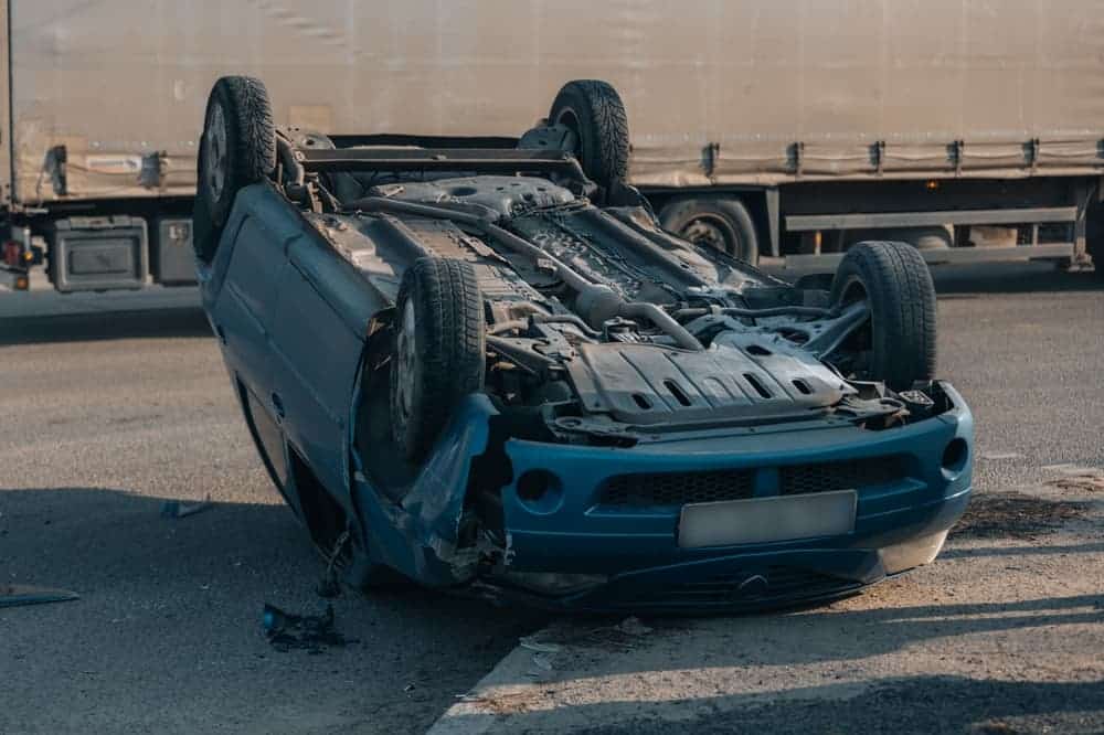 Road traffic accident. Overturned car on the highway.