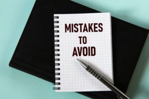 MISTAKES TO AVOID - words in a white notebook