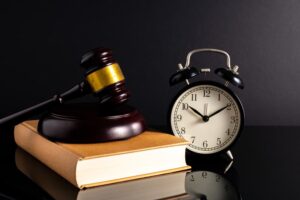 Gavel, law book with low clock