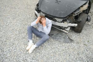 Man after car accident. Man regrets damage caused during car wreck.