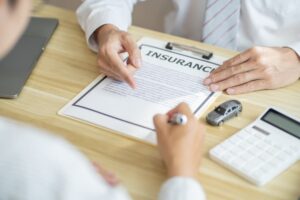 Loss Adjuster Insurance Agent Inspecting Damaged Car