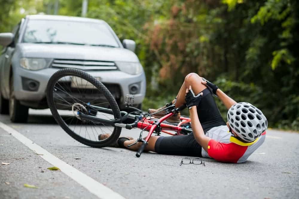 A bicyclist was injured in a collision with a car on the road.